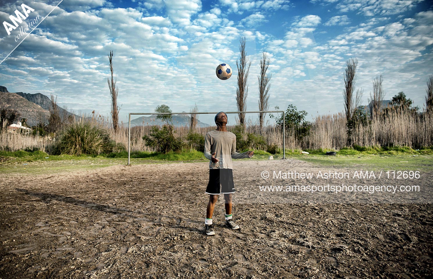 03 July 2010 - South Africa - Hout Bay, Cape Town - A young boy playing football in Hout Bay, Cape Town, South Africa on a dirt football pitch
