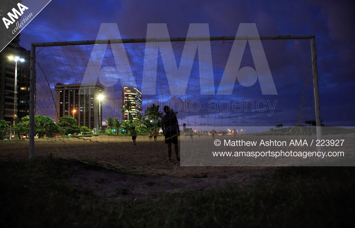 17 June 2013 - Football in Recife, Brazil - Youngsters play floodlit football on the beach of Recife in the state of Pernambuco, Brazil during dusk