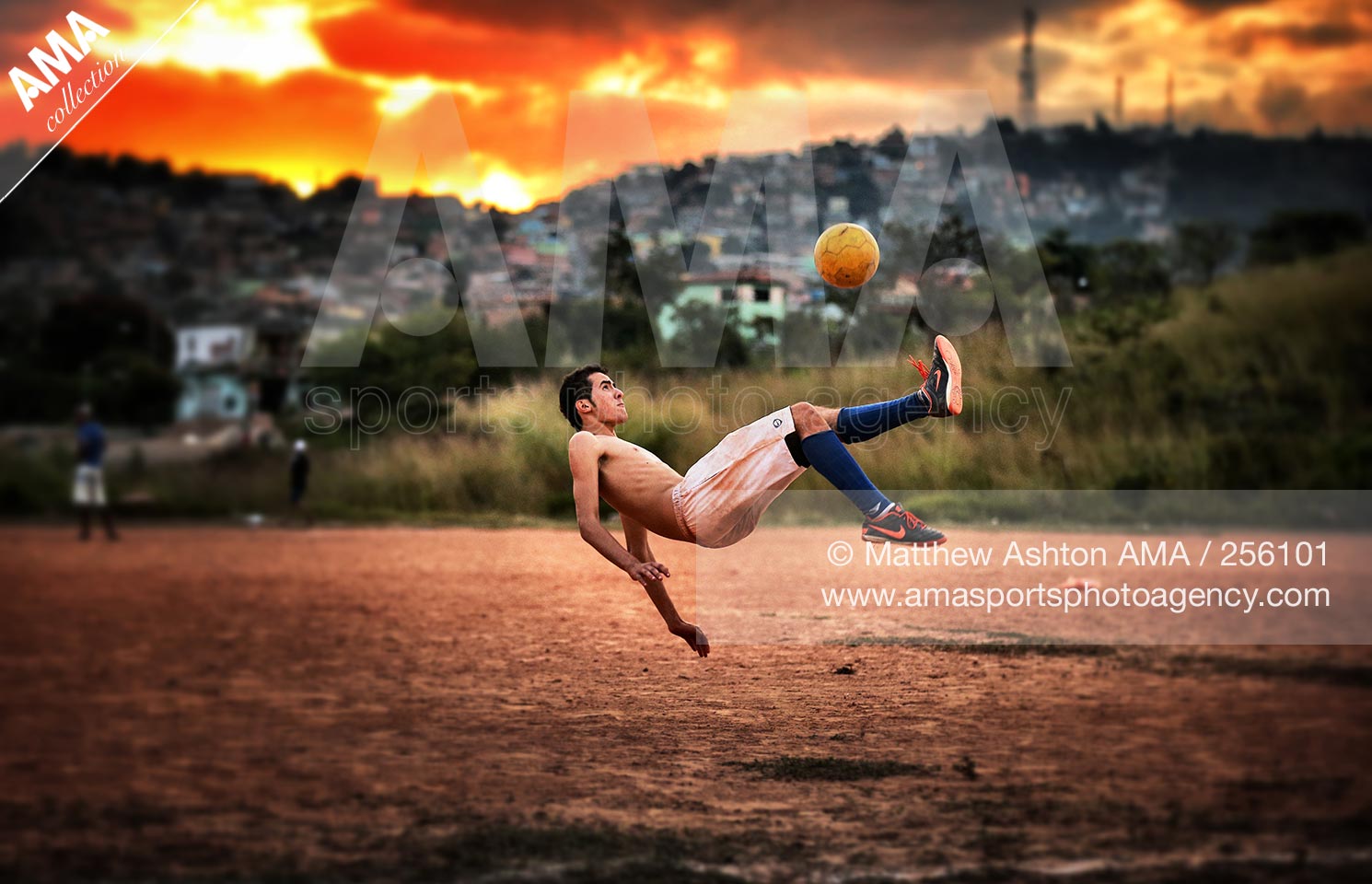 25 Jun 2013 - Belo Horizonte, Brazil - A local footballer does an over head kick on a dust football pitch in Belo Horizonte - Minas Gerais, Brazil 