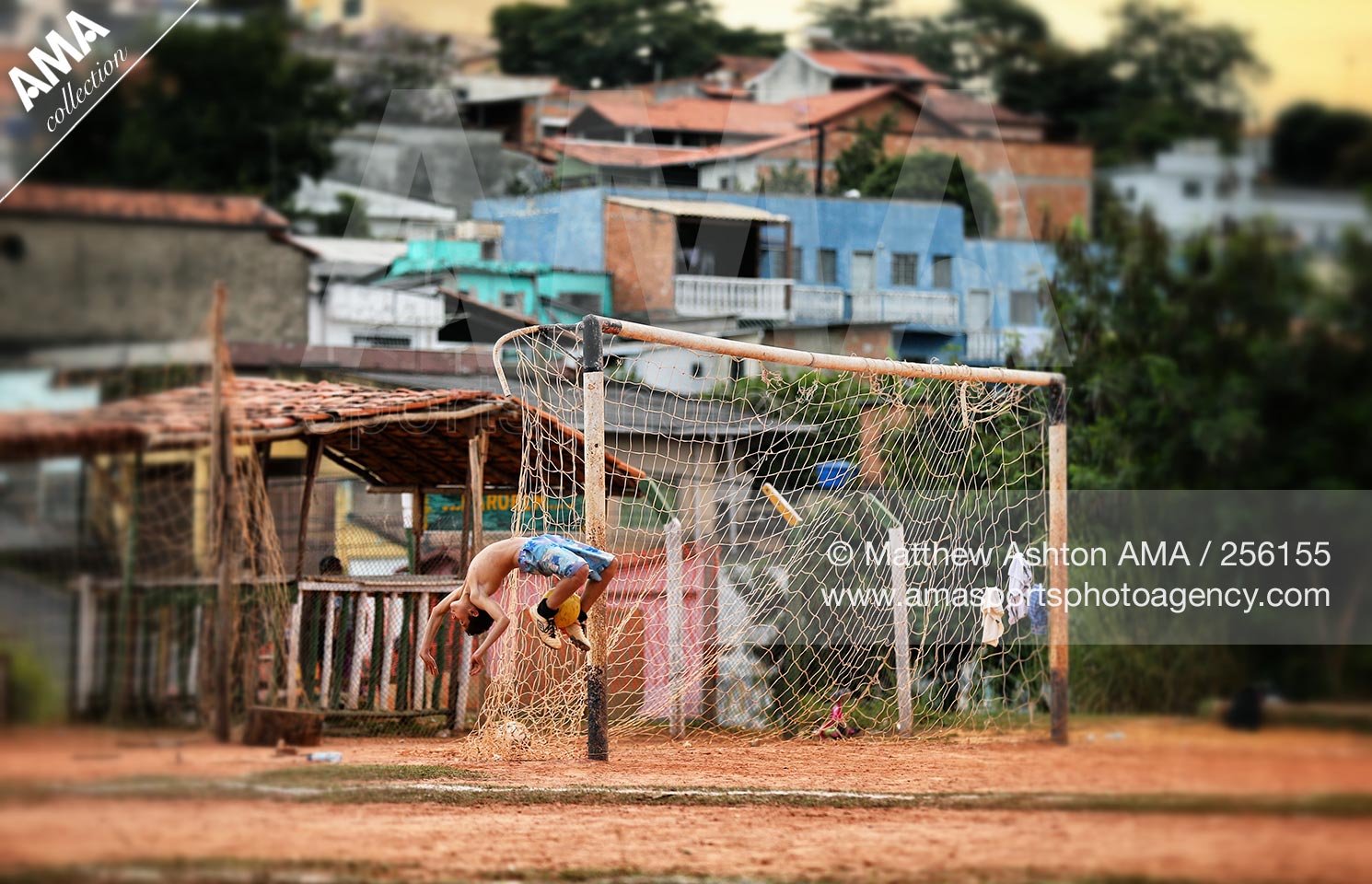 25 Jun 2013 - Belo Horizonte, Brazil - A local footballer does an over head flip on a dust football pitch in Belo Horizonte - Minas Gerais, Brazil 