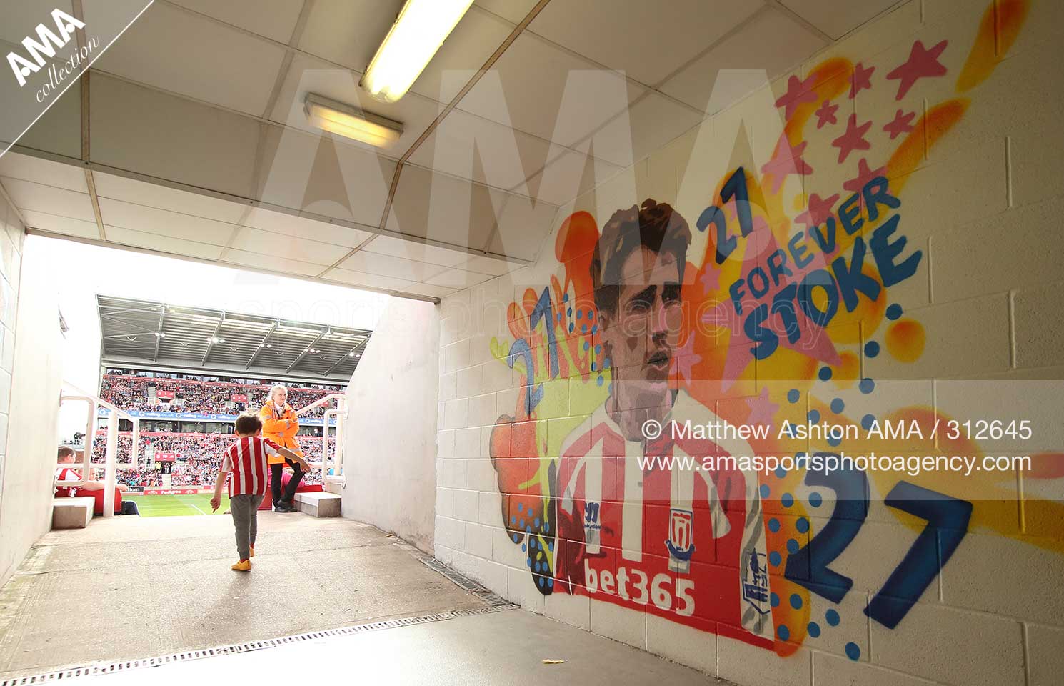 9 August 2015 Barclays Premier League - Stoke City v Liverpool  - A young fan of Stoke City makes his way back to his seat in the second half walking past a mural of Bojan Krkic of Stoke City at The Britannia Stadium  © Matthew Ashton / AMA 312645