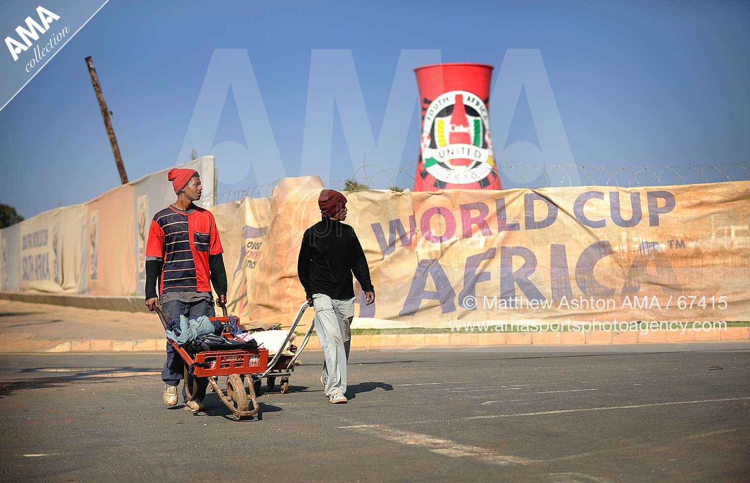 Locals walk past the construction of Soccer City, the stadium venue for the 2010 South Africa FIFA World Cup in Johannesburg