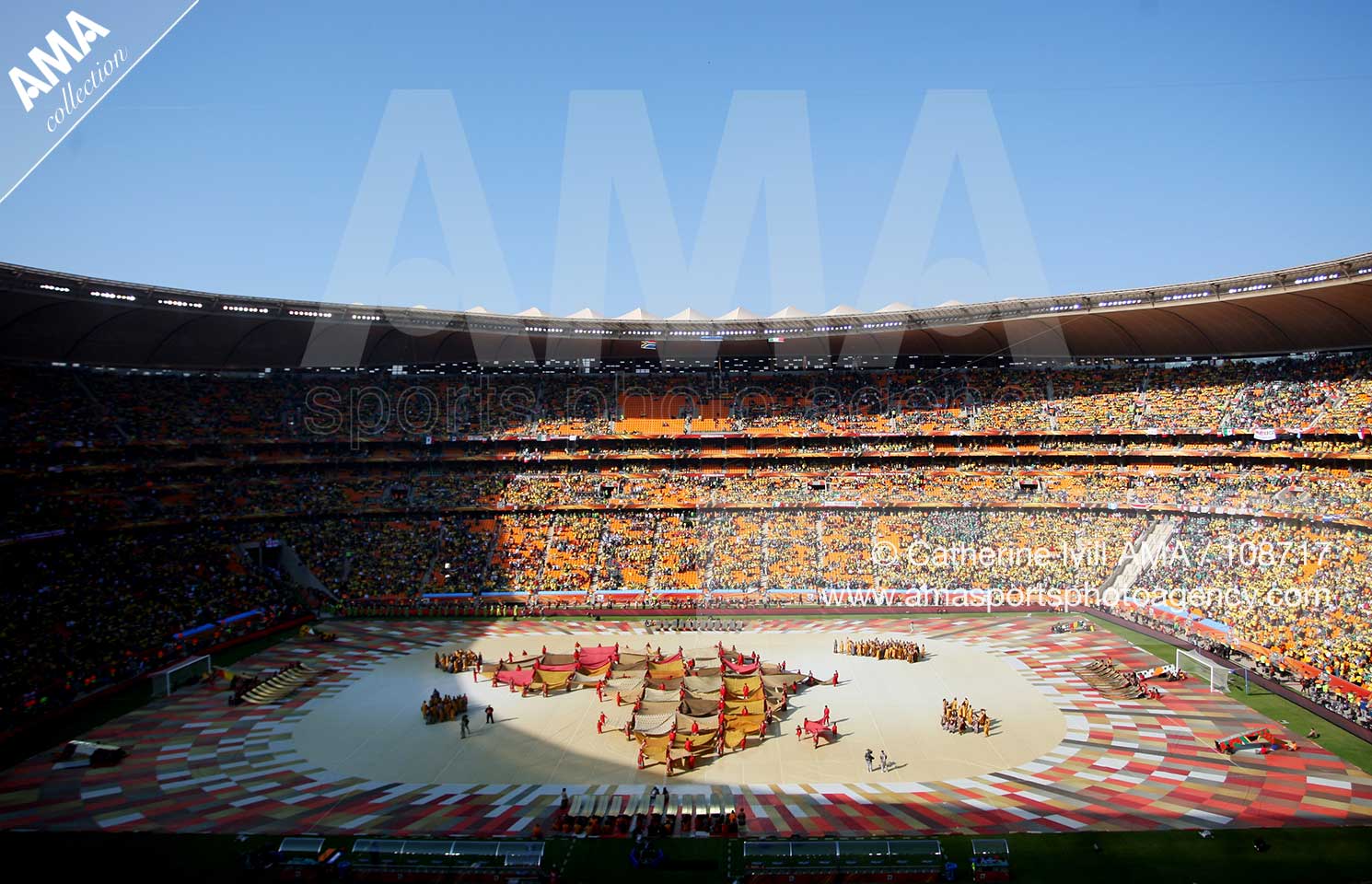 Dancers hold up flags which make up the shape of South Africa at Soccer City stadium during the opening ceremony of the 2010 FIFA World Cup