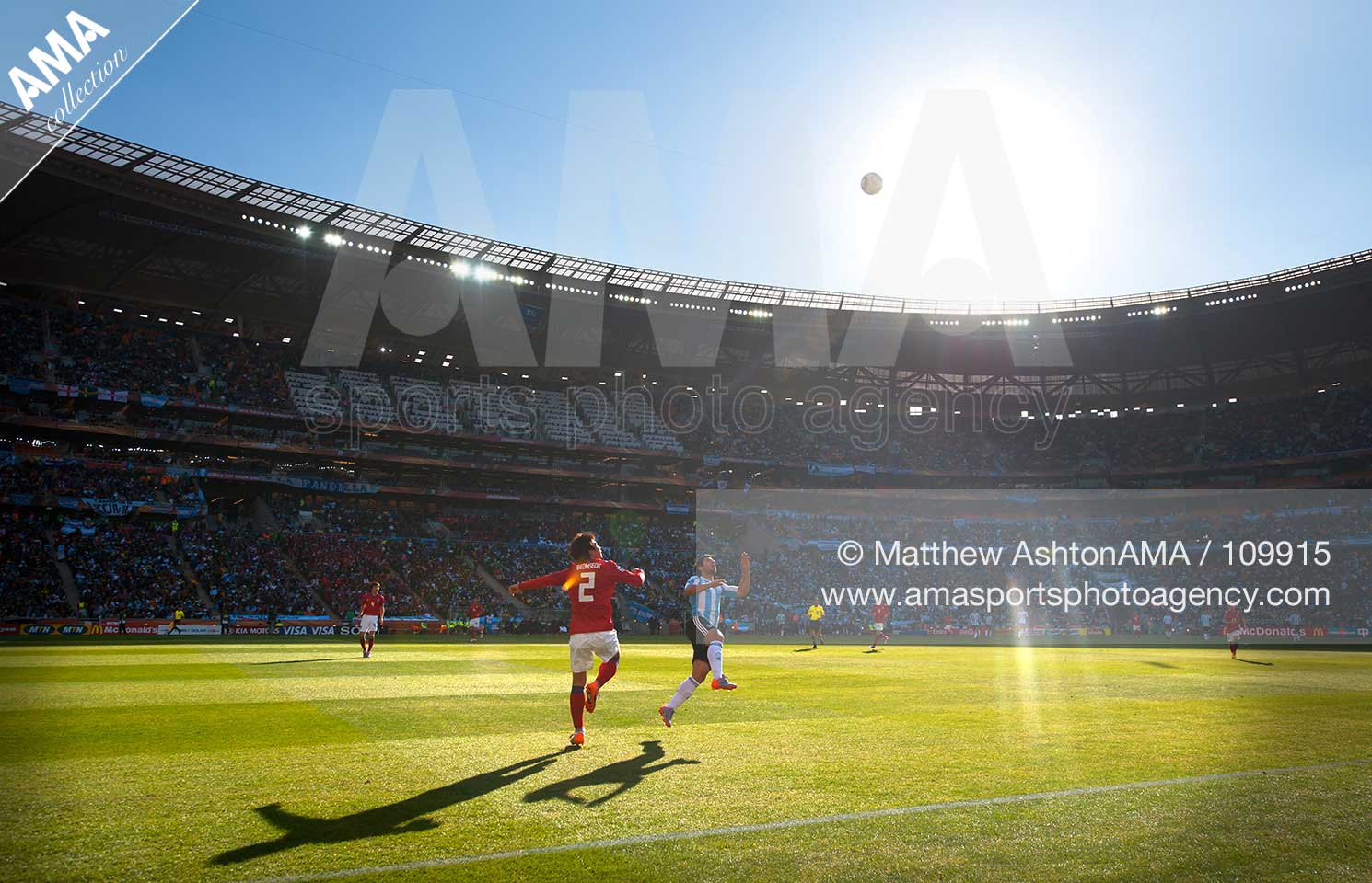 Oh Beom Seok of South Korea and Sergio Aguero of Argentina wait for the ball to drop from the sky at Soccer City Stadium