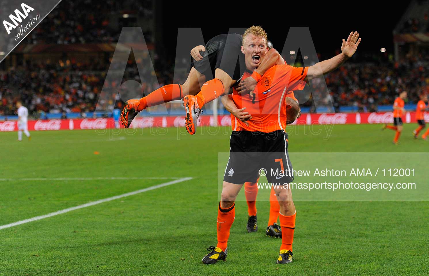 Dirk Kuyt of Netherlands lifts up Wesley Sneijder of Netherlands to celebrate after Sneijdner scored to make it 2-0