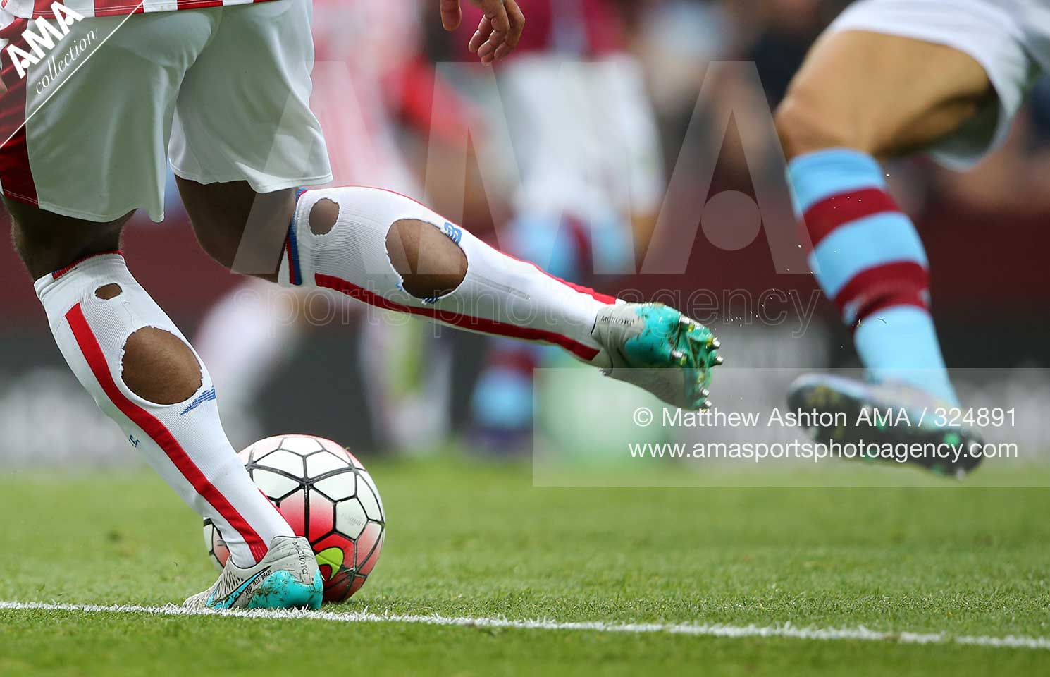 Barclays Premier League - Aston Villa v Stoke City - Glen Johnson of Stoke City clears the ball with holes in his white socks