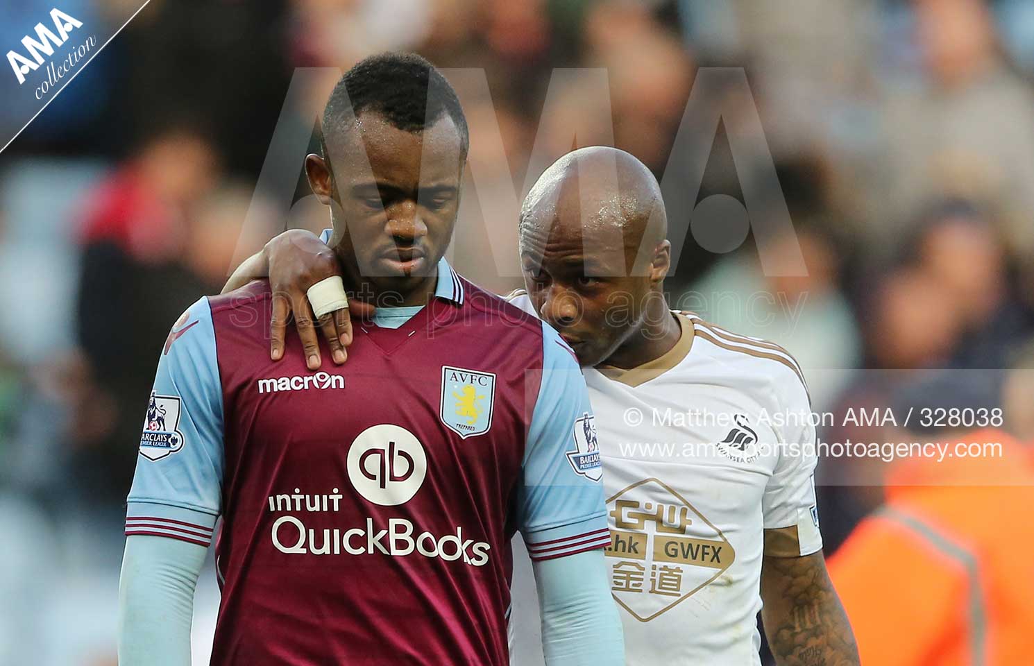 Barclays Premier League - Aston Villa  v Swansea City - Scorer of the winning goal, Andre Ayew of Swansea City tries to console his brother Jordan Ayew of Aston Villa 