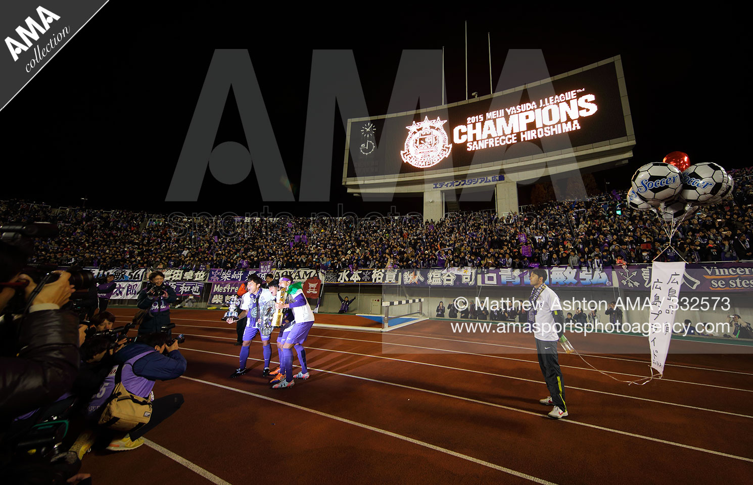 2015 J League Championship Final Second Leg - Sanfrecce Hiroshima v Gamba Osaka - Sanfrecce Hiroshima have their photographs taken with the trophies as they celebrate winning the J.League 2015 Championship MATTHEW ASHTON AMA SPORTS PHOTO AGENCY