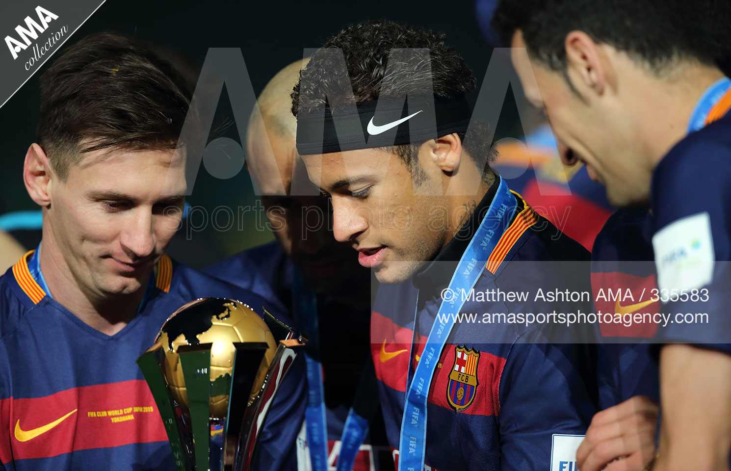 Lionel Messi and Naymar of FC Barcelona look at the trophy during the FIFA Club World Cup Final 