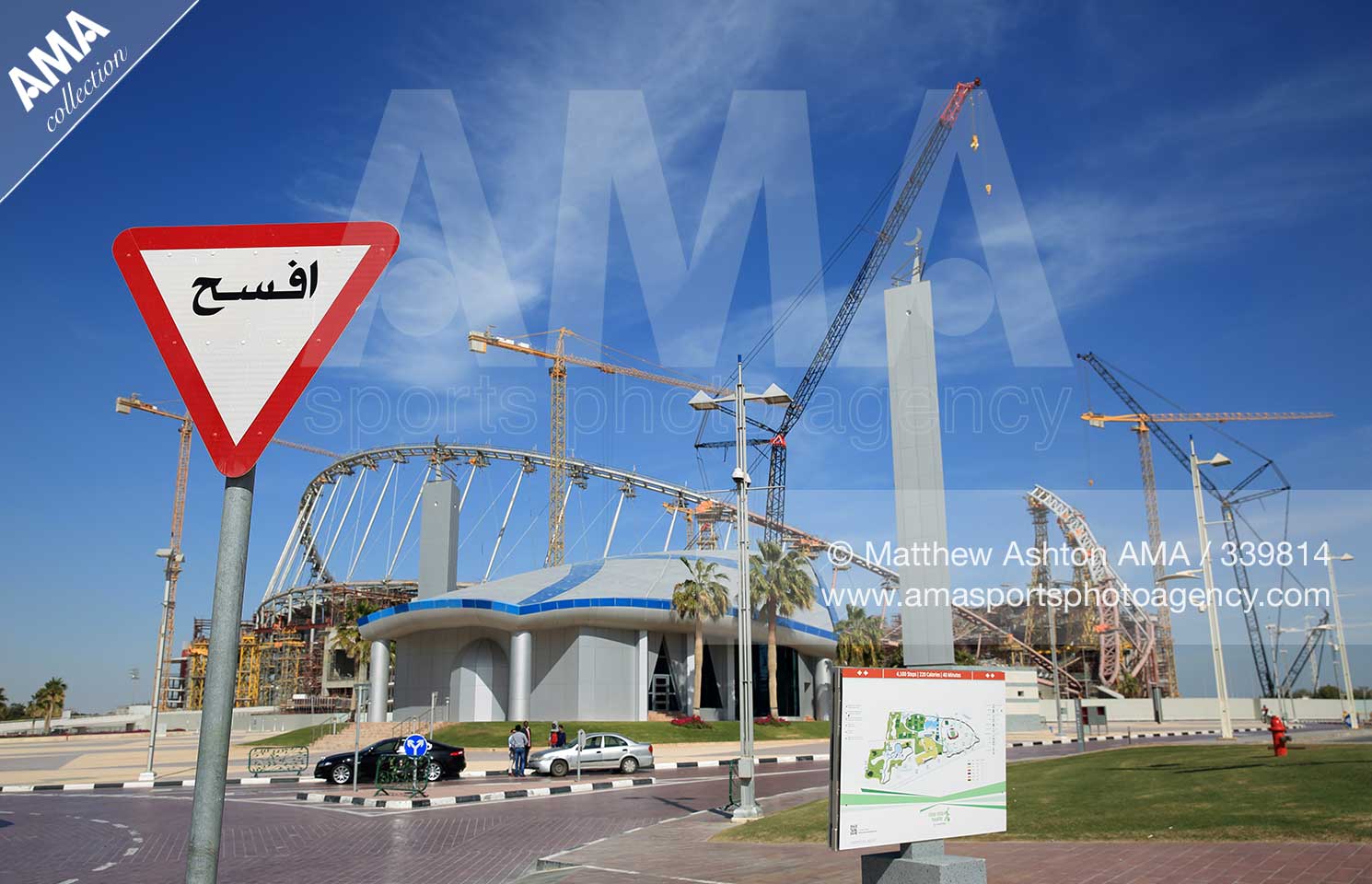 Khalifa International Stadium, Doha, Qatar - A GIVE WAY sign in arabic alongside the construction and refurbishment of the Khalifa International Stadium also known as National Stadium, in Doha, Qatar and venue for the FIFA World Cup Final 2022