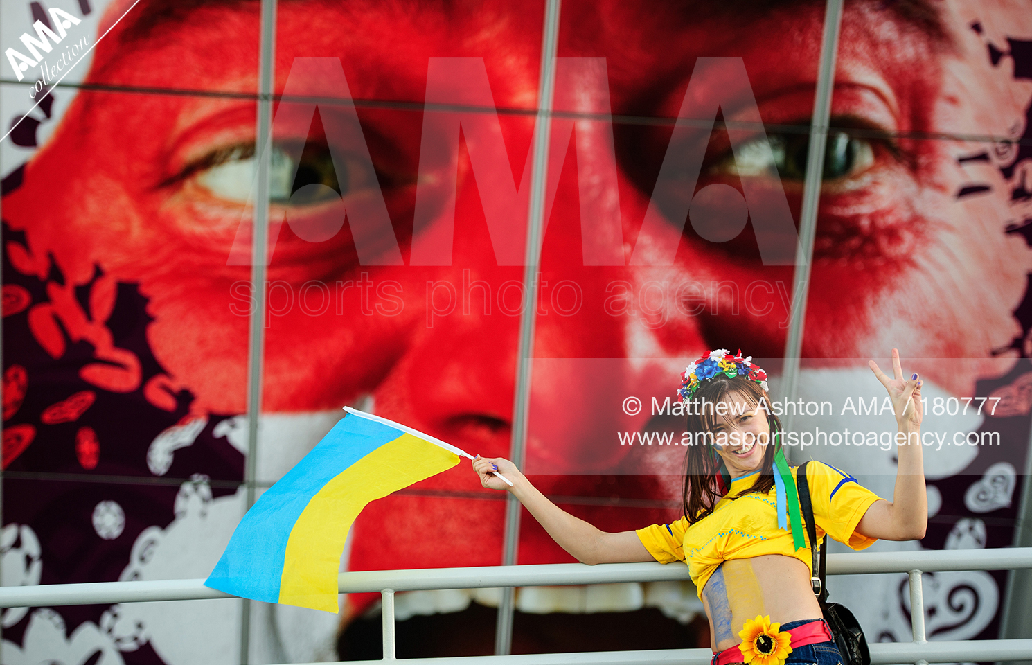 UEFA European Championships  Euro 2012 - Group D - England v Ukraine - A female fan of the Ukraine in front of a stadium picture of an England fan 180777