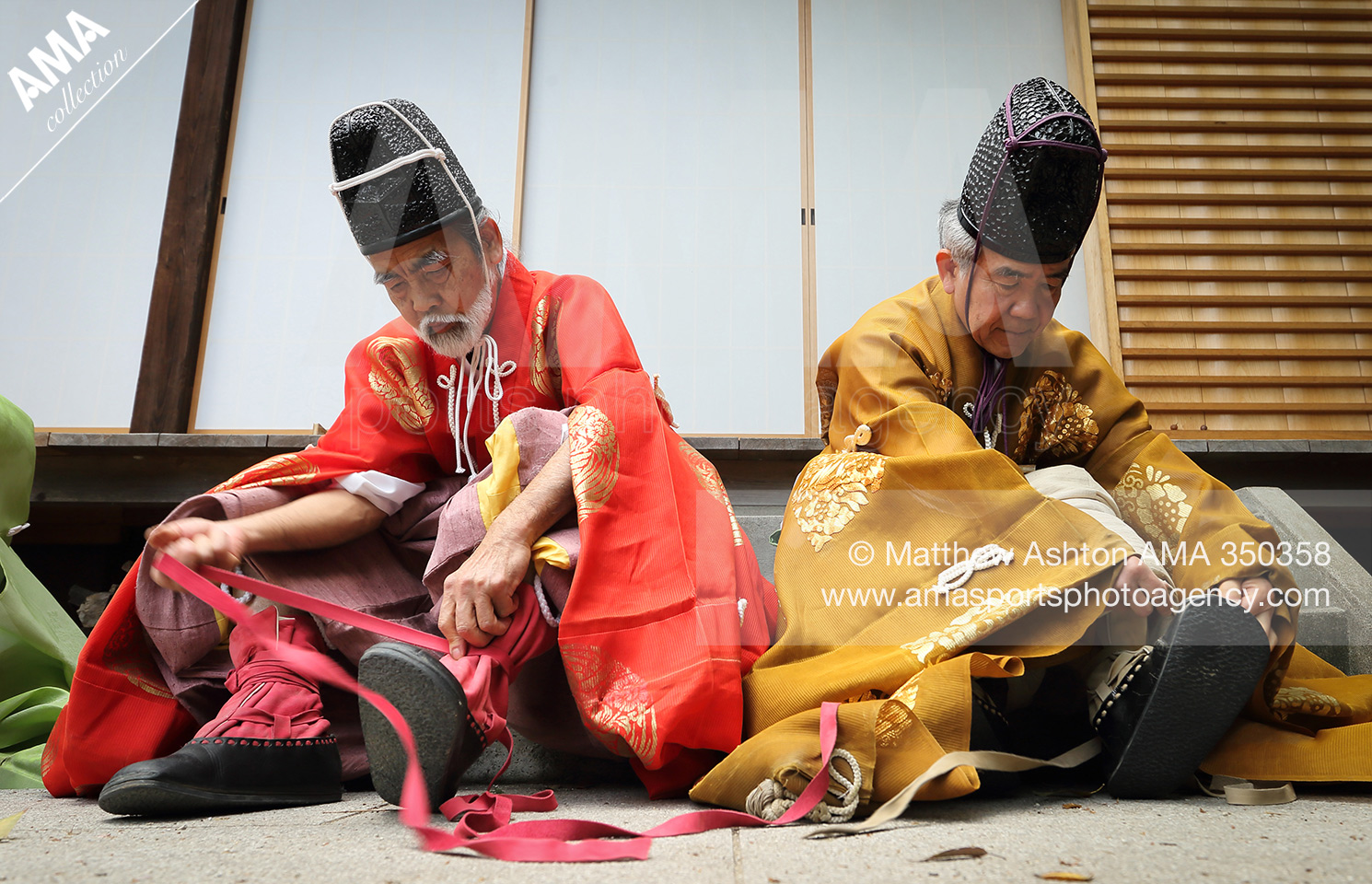 Players put on their ancient leather football boots prior to an exhibition of Kemari at Shiramine Shrine