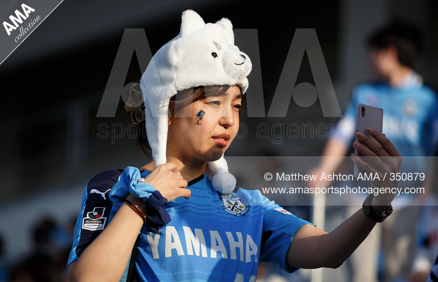 J.League - Jubilo Iwata v Yokohama F.Marinos - A female fan of Jubilo Iwata takes a selfie picture of herself using her mobile telephone 