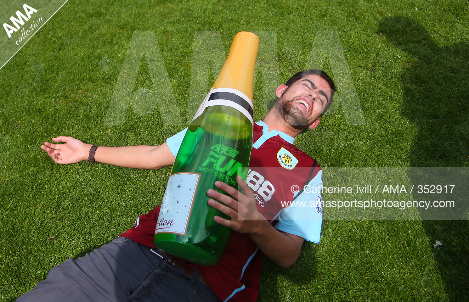 07 May 2016 - Sky Bet Championship - Charlton Athletic v Burnley - A Burnley fan celebrates promotion to the Premier League with an inflatable bottle of champagne © Catherine Ivill AMA 352917