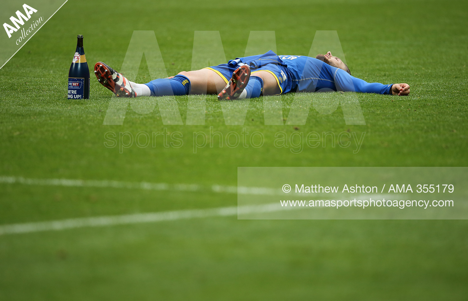 30 May 2016 - Sky Bet League Two Play Off Final - Plymouth Argyle v AFC Wimbledon - Callum Kennedy of AFC Wimbledon takes a time out on the pitch as he celebrates promotion after victory in the Sky Bet League Two Play Off Final © Matthew Ashton AMA 355179