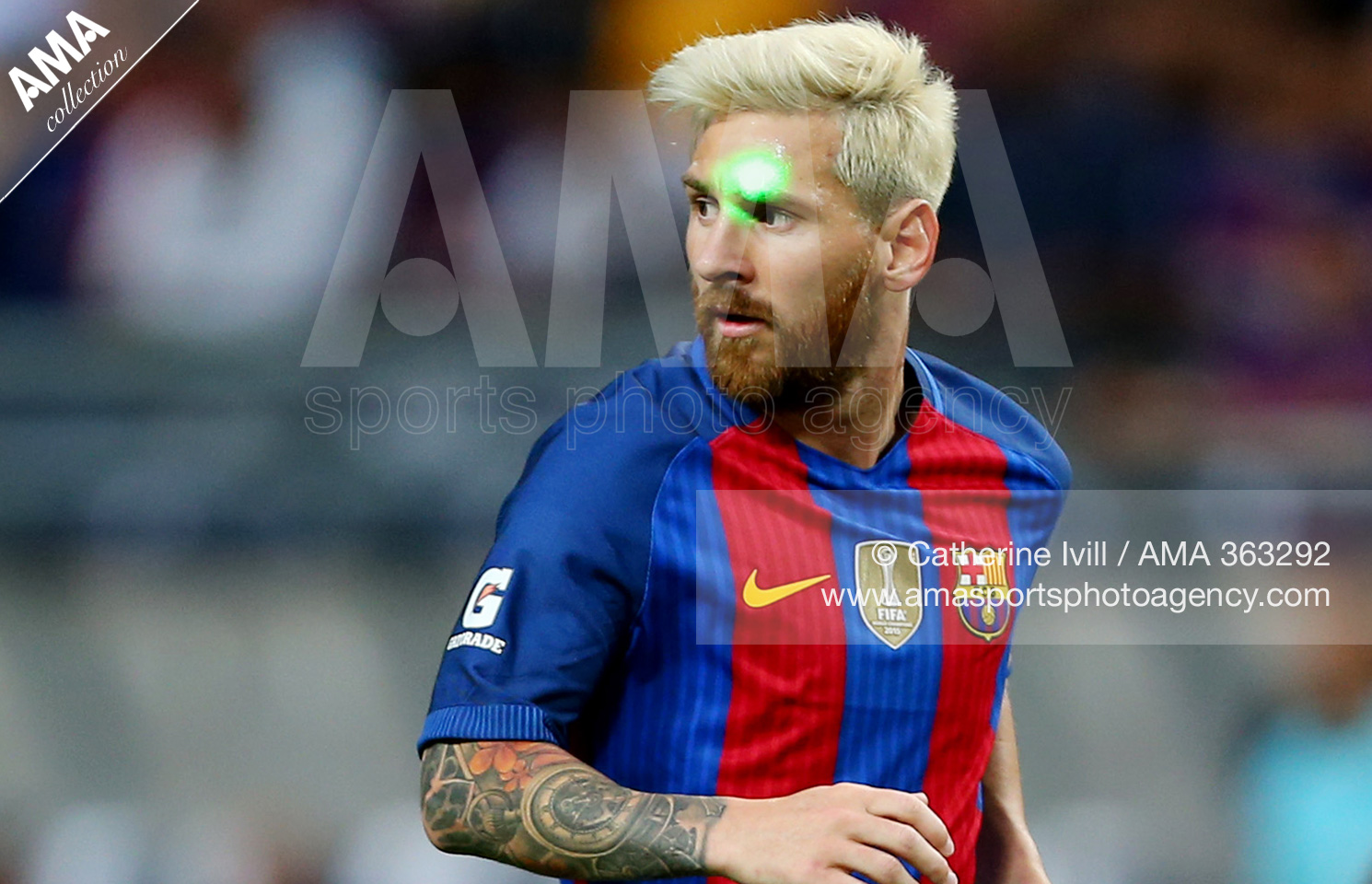 A green laser is shone in the face of Lionel Messi of FC Barcelona